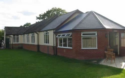 Denton Village Hall is a single-story building built of red brick and roofed in slate